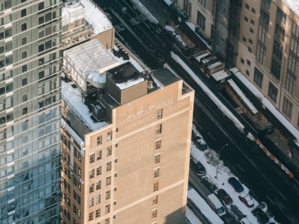 snowy city street with modern multistage buildings in daylight